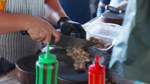 Cutting a strip of pork in the kitchen Stock Footage 300849445