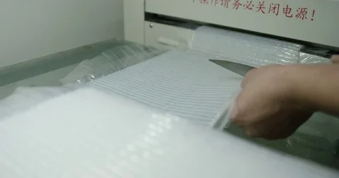 Cutting Strips of Corrugated Material Stock Footage 73076158