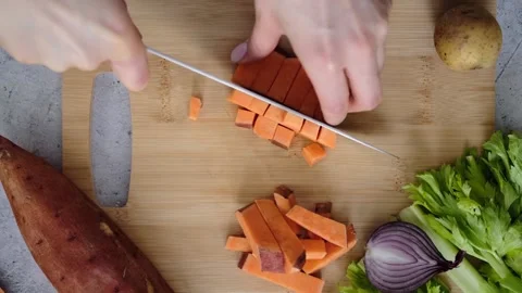 Cutting sweet potatoes into cubes Stock Footage 170665493