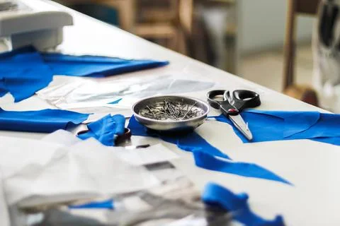 Cutting table in a sewing workshop: the workflow of cutting clothing parts. Stock Photos