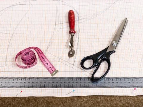 Cutting table with textile, pattern, tailor tools Stock Photos
