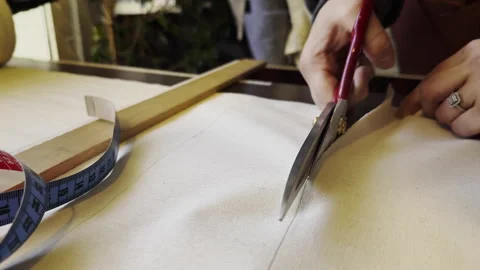Cutting the Thick Fabric with Scissors in The Tailor Workshop Stock Footage 296448127