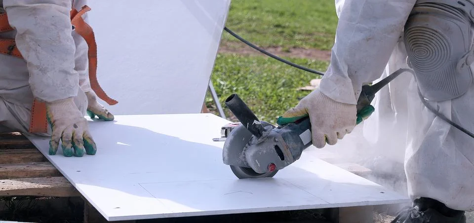 Cutting Through White Material With a Powerful Grinder Outdoors Stock Photos