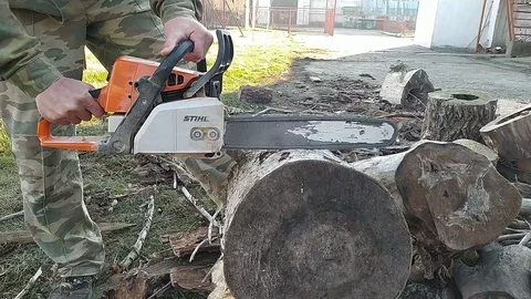 Cutting through wood with chainsaw in slow motion Stock Footage 121587892