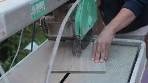 Cutting tile with a wet saw medium shot.mp4 Video stock 42998113