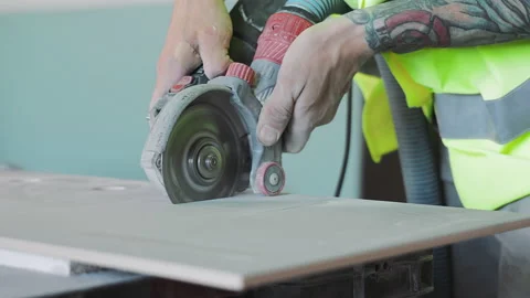 Cutting Tiles close-up with an Electric tile Cutter Stock Footage 219357849