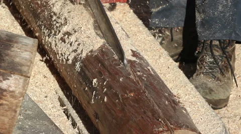 Cutting timber onto halves using chainsaw -zoom out Stock Footage 57273760