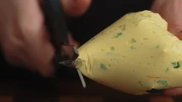 Cutting tip off of piping bag Stock Footage 85476161