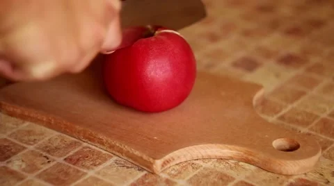 Cutting tomato on kitchen table Stock Footage 65610330