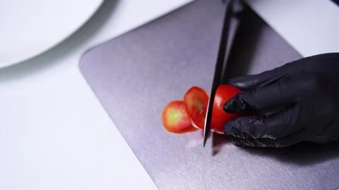 Cutting Tomato with Knife on Titanium Board. Close-Up Fresh Food Prep Footage. Stock Footage 323206687