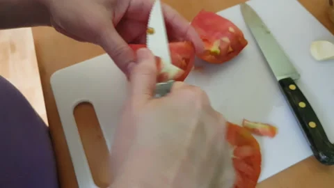 Cutting a tomato to make a salad Stock Footage 136028654