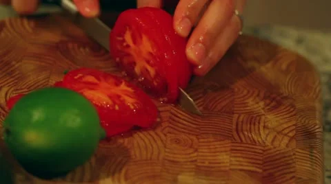 Cutting a tomato for salad Stock Footage 21470358
