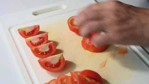 Cutting a Tomato into Slices, Halves and Small Diced Pieces Stock Footage 346304459