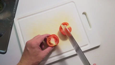 Cutting a Tomato into Slices, Halves and Small Diced Pieces Stock Footage 346304686