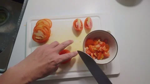 Cutting a Tomato into Slices, Halves and Small Diced Pieces Stock Footage 346305125
