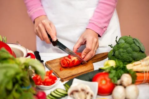Cutting of tomato in slices Stock Photos