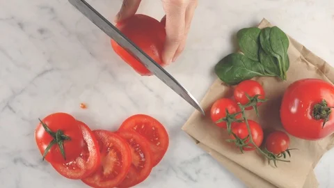 Cutting tomato, tomatoes sliced background, top view fresh ingredient for salad  Video stock 123426940