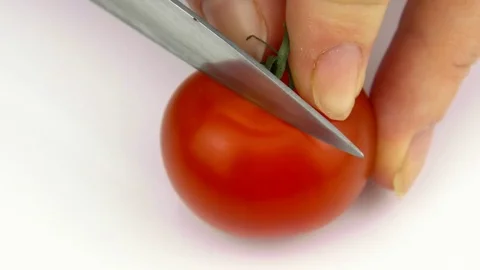 Cutting tomato on white background close-up Stock-Footage 83055565