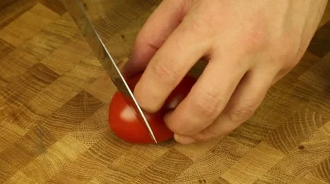 Cutting tomatoes into the board Stock Footage 61048828