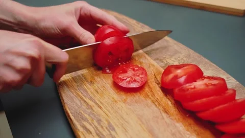 Cutting tomatoes on a cutting board Video stock 249374442