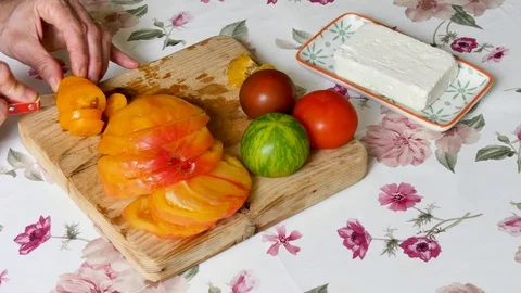 Cutting tomatoes in a kitchen. Stock Footage 94961569