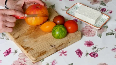 Cutting tomatoes in a kitchen. Video stock 94961771