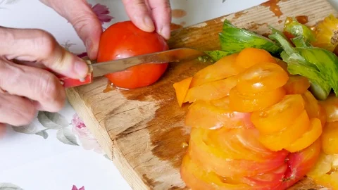 Cutting tomatoes in a kitchen. Video stock 94961961
