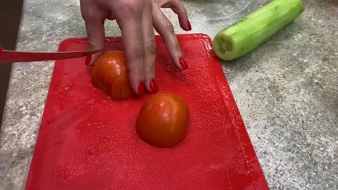 Cutting tomatoes with a knife Stock Footage 123968056