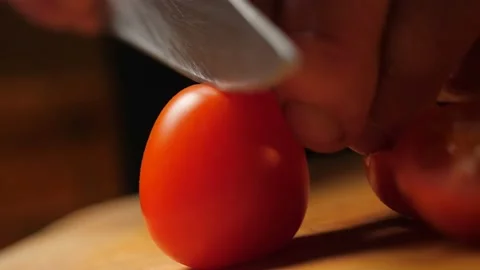 Cutting tomatoes with a knife. Macro view. Slow motion. Closeup, Stock Footage 132870126