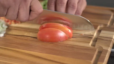 Cutting tomatoes to make the salad Stock Footage 160622353