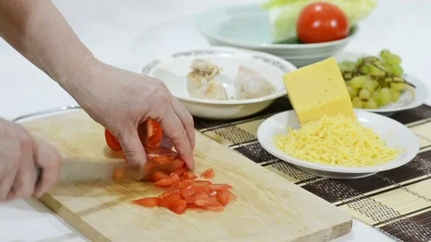 Cutting tomatoes for the salad Stock Footage 83293907