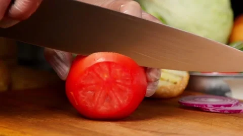 Cutting tomatoes in slow motion Stock Footage 67856980
