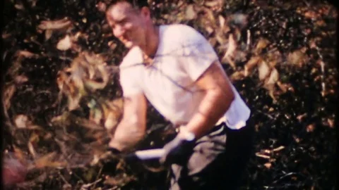 Cutting trees and brush burning it in the backyard 1950s vintage home movie 4015 Stock Footage 72166869