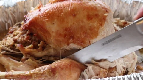 Cutting Turkey Leg Off Slicing with Large Knife Dark Meat Stock Footage 145874732