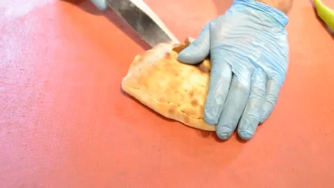 Cutting turkish bread with a knife Stock Footage 243717379