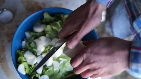 Cutting a turnip with a sharp knife. Only the hands of the man can be seen 動画素材 159721077