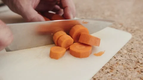 Cutting two carrots in slow motion Stock Footage 284180274