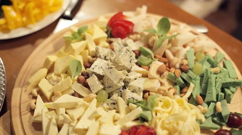 Cutting from various cheeses with strawberries, nuts and grapes on catering Stock Footage 51912676