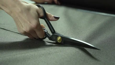 Cutting various types of fabric with quality scissors in a productive workshop Stock Footage 310248949