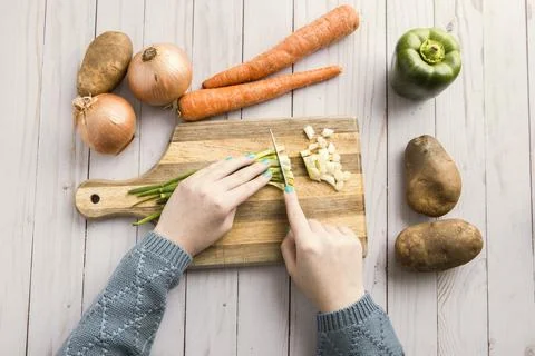 Cutting up various veggies. Stock Photos