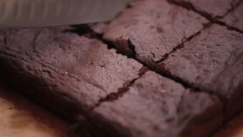 Cutting vegan banana chocolate brownie with a knife Stock Footage