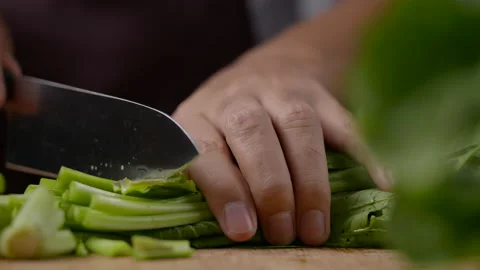 Cutting a vegetable with knife in slow motion Stock-Footage 153507192