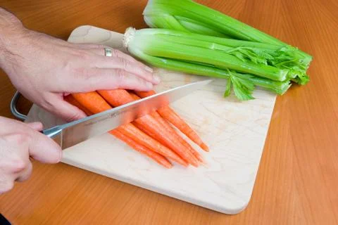 Cutting vegetables on board Stock Photos