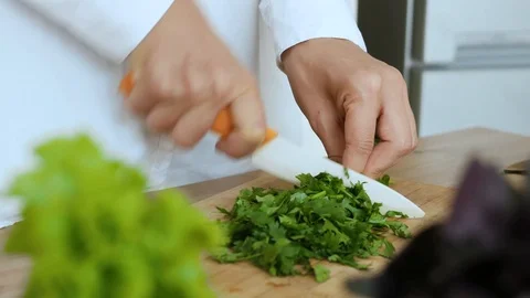 Cutting vegetables, closeup hands cutting vegetables, greenery Stock Footage 112135765