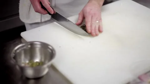 Cutting vegetables in a cutting board in the kitchen Stock Footage 307340114
