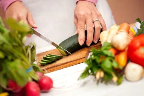 Cutting vegetables on cutting board Stock Photos