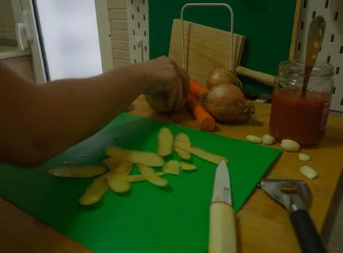 Cutting vegetables in the kitchen Stock Photos