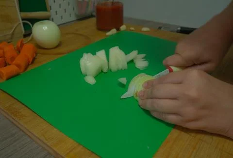Cutting vegetables in the kitchen Stock Photos