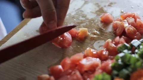 Cutting vegetables with a knife, tomatoes, cucumbers, onions, greens Stock Footage 91853508