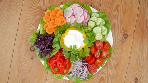 Cutting vegetables on a plate. Stock Footage 232027894